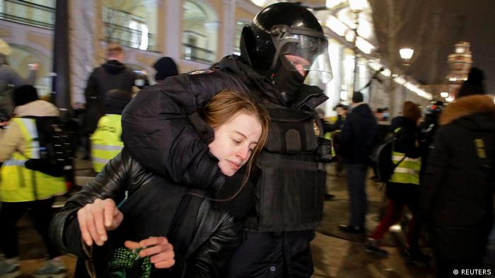A female protester being held in a choke hold by a riot police officer in St Petersburg on March 2