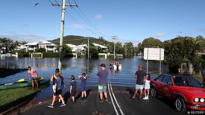 People standing at a flooded street in Cabarita