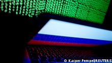 FILE PHOTO: A Russian flag is seen on the laptop screen in front of a computer screen on which cyber code is displayed, in this illustration picture taken March 2, 2018. REUTERS/Kacper Pempel/Illustration/File Photo