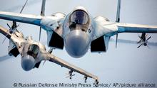 In this photo released by the Russian Defense Ministry Press Service, a pair of Russian Su-35 fighter jets fly in the sky in Russia, Sunday, Nov. 28, 2021. The Ukrainian and Western officials have expressed concern that a Russian military buildup near Ukraine could signal plans by Moscow to invade its ex-Soviet neighbor. (Russian Defense Ministry Press Service via AP)