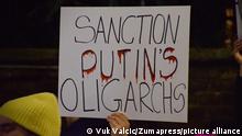February 23, 2022, London, England, United Kingdom: A protester holds a 'Sanction Putin's Oligarchs' placard. Demonstrators gathered outside the Russian Embassy in London in protest against the Russian invasion of Ukraine. (Credit Image: Â© Vuk Valcic/ZUMA Press Wire
