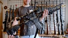 File photo dated January 7, 2016 of Jeremiah Karrasch owner of the gun store, holds a AG43 automatic rifle in Arlington Virginia after President Barack Obama on Tuesday made a passionate call for a national sense of urgency to limit gun violence. As the number of Covid-19 coronavirus infections rises, many Americans are going to retailers, pawnshops and online to purchase guns and ammunition. Photo by Olivier Douliery/ABACAPRESS.COM