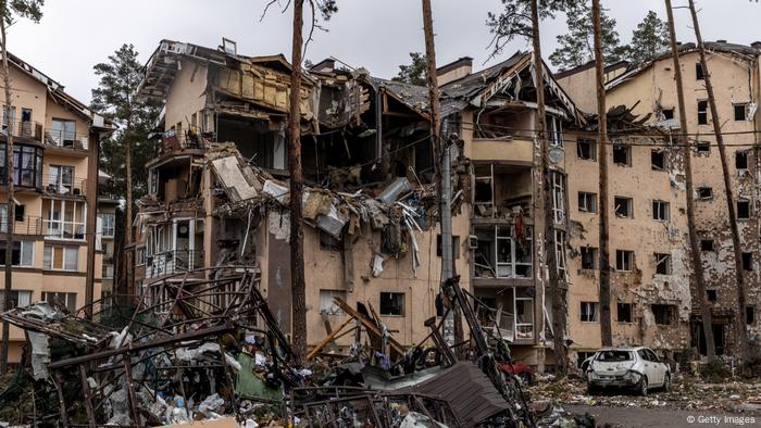 A row of destroyed apartment buildings in Irpin