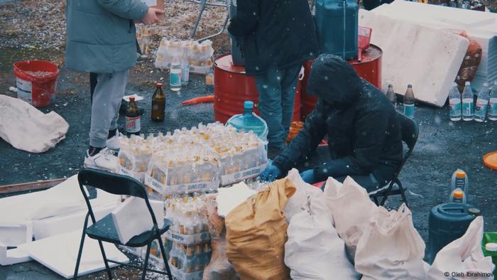 People making Molotov cocktails