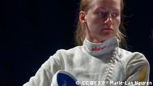 Olena Kryvytska stands in her fencing gear