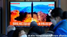 People watch a TV showing a file image of North Korea's missile launch during a news program at the Seoul Railway Station in Seoul, South Korea, Sunday, Feb. 27, 2022. North Korea on Sunday launched a suspected ballistic missile into the sea, South Korean and Japanese officials said, in an apparent resumption of its weapons tests following the end of the Winter Olympics in China, the North's last major ally and economic pipeline. The letters read The presidential National Security Council (NSC) held an emergency meeting. (AP Photo /Ahn Young-joon)