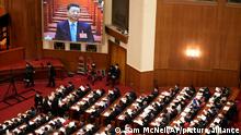 A video screen shows Chinese President Xi Jinping during the opening session of the annual meeting of China's National People's Congress (NPC) at the Great Hall of the People in Beijing, Saturday, March 5, 2022. (AP Photo/Sam McNeil)