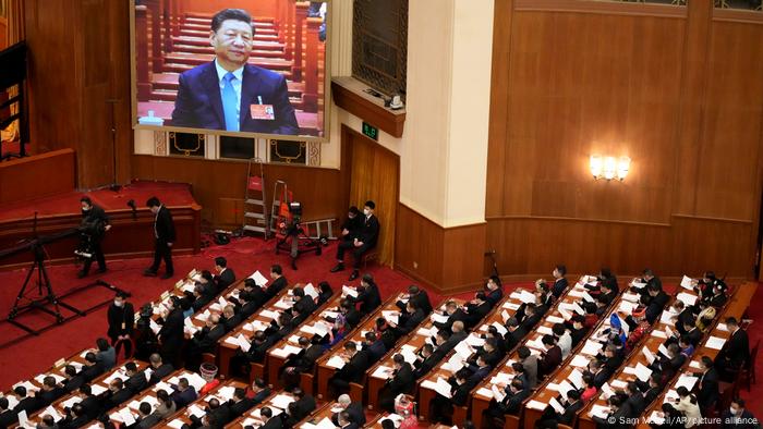 A video screen shows Chinese President Xi Jinping during the opening session of the annual meeting of China's National People's Congress.