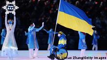 BEIJING, CHINA - MARCH 04: Flag bearer Maksym Yarovyi of Team Ukraine leads their team out during the Opening Ceremony of the Beijing 2022 Winter Paralympics at the Beijing National Stadium on March 04, 2022 in Beijing, China. (Photo by Lintao Zhang/Getty Images)