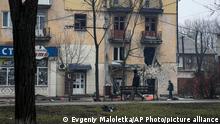 A man walks past an apartment building hit by shelling in Mariupol, Ukraine, Wednesday, March 2, 2022. (AP Photo/Evgeniy Maloletka)
