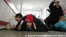 People lie on the floor of a hospital during shelling by Russian forces in Mariupol, Ukraine, Friday, March 4, 2022. (AP Photo/Evgeniy Maloletka)