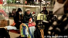epa09802543 Refugees from Ukraine rest at Berlin central station Hauptbahnhof in Berlin, Germany, 04 March 2022. Russian troops entered Ukraine on 24 February prompting the country's president to declare martial law and triggering a series of announcements by Western countries to impose severe economic sanctions on Russia. Refugees fleeing Ukraine are brought by trains, among other destinations, to the German capital. EPA-EFE/FILIP SINGER