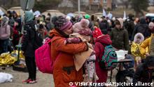 A woman kisses a child after fleeing from the Ukraine and arriving at the border crossing in Medyka, Poland, Monday, March 7, 2022. Russia announced yet another cease-fire and a handful of humanitarian corridors to allow civilians to flee Ukraine. Previous such measures have fallen apart and Moscow’s armed forces continued to pummel some Ukrainian cities with rockets Monday. (AP Photo/Visar Kryeziu)