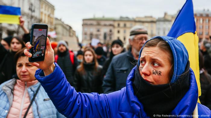 protester with a phone in Krakow, Poland