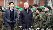 Canadian Prime Minister Justin Trudeau, left, and NATO Secretary General Jens Stoltenberg walk during their visit to Adazi Military base in Kadaga, Latvia, Tuesday, March. 8, 2022. (AP Photo/Roman Koksarov)