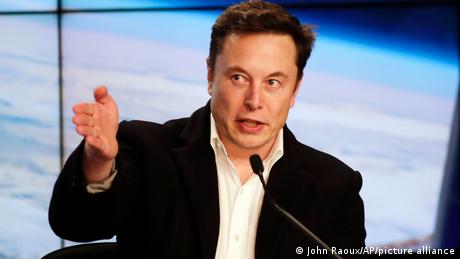  Elon Musk gestures while speaking at a news conference in Florida