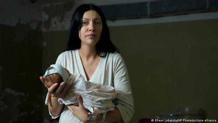 A woman holds her baby girl in the basement of a Kyiv maternity hospital
