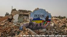 February 24, 2022: Graffiti Aziz Al-Asmar and Anis Hamdoun draw a painting on the destroyed walls in Idlib Governorate, northern Syria, and the painting expresses solidarity with the Ukrainian people against the Russian invasion to which they are exposed. - ZUMAa323 20220224_zip_a323_007 Copyright: xMoawiaxAtrashx 