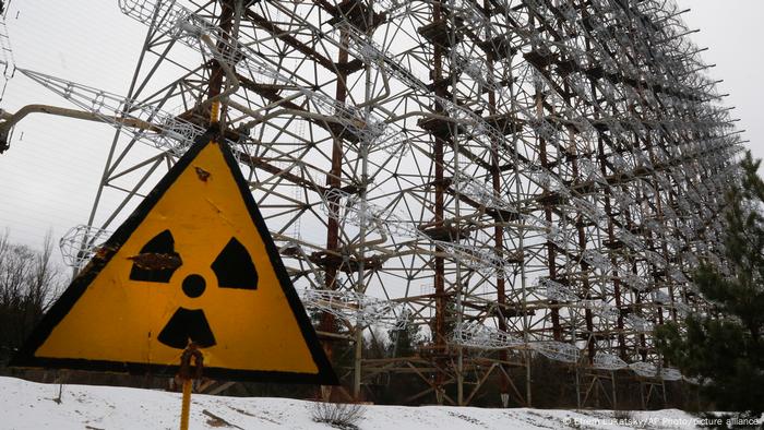 A Soviet-era top secret object Duga, an over-the-horizon radar system once used as part of the Soviet missile defense early-warning radar network, seen behind a radioactivity sign in Chernobyl A Soviet-era top secret object Duga, an over-the-horizon radar system once used as part of the Soviet missile defense early-warning radar network, seen behind a radioactivity sign in Chernobyl