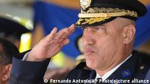 FILE - In this Dec. 21, 2012 file photo, Honduras Police Chief Gen. Juan Carlos Bonilla Valladares, also known as the Tiger, or El Tigre, salutes during an event in Tegucigalpa, Honduras. The former chief of the Honduran National Police faces drug and weapons charges in New York, where prosecutors claimed on Thursday, April 30, 2020, that he traded his law enforcement clout to protect U.S.-bound shipments of cocaine. (AP Photo/File)