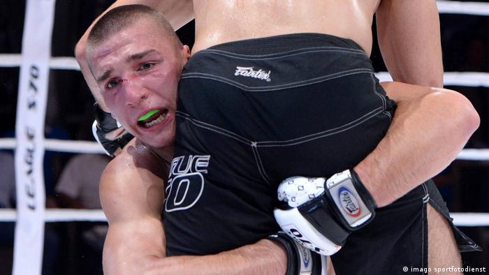 Yaroslav Amosov grapples during an MMA fight