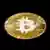 Foto del logo de Bitcoin sobre una moneda dorada.