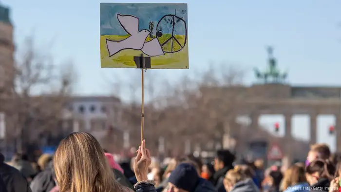 People demonstrating in support of International Women's Day gather in front of the Russian embassy