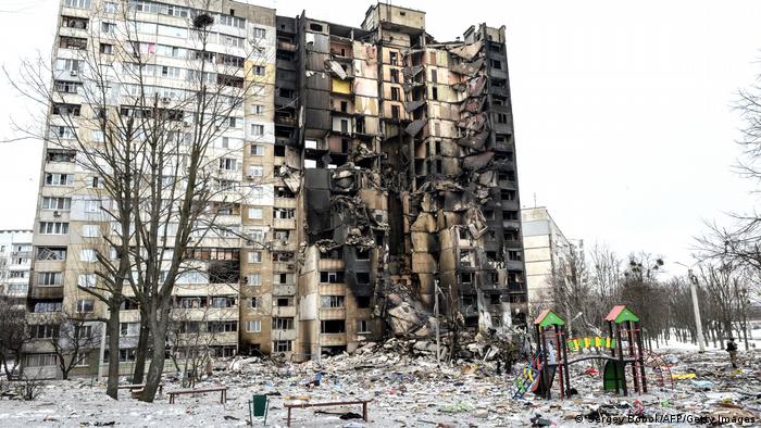 A destroyed apartment block in the eastern city of Kharkiv, an abandoned playground in the foreground.