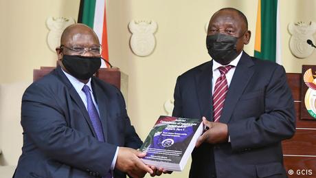 Judge Raymond Zondo hands the first part of the report of the Judicial Commission of Inquiry into Allegations of State Capture to South Africa's President Cyril Ramaphosa