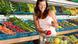 Woman buys fruit at supermarket Woman buys fruit at supermarket