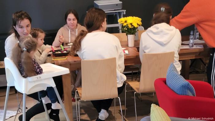 Jewish refugees sitting at a table in the Hillel education facility in Warsaw