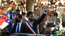 Chile's new President Gabriel Boric waves as he arrives at La Moneda presidential palace, in Santiago, Chile, Friday, March 11, 2022. The left-leaning former student leader was sworn in as Chile’s new president on Friday, vowing to oversee a political and economic renovation. (AP Photo/Matias Delacroix)