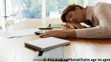 Tired businessman sleeping in office Copyright: EricxAudras B42410745