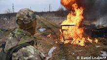 A Ukrainian soldier looks at flames after throwing a cocktail Molotov�s during a self-defence civilian course on the outskirts of Lviv, western Ukraine, on March 4, 2022. - The Russian army occupied on March 4, 2022 the Ukrainian nuclear power plant of Zaporozhie (south), the largest in Europe, where bombings in the night have raised fears of a disaster as more than 1.2 million people have fled Ukraine into neighbouring countries since Russia launched its full-scale invasion on February 24, United Nations figures showed on March 4, 2022. (Photo by Daniel LEAL / AFP)