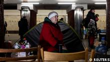 A woman sits next to a tent inside a metro station that serves as a shelter from possible air raids, as Russia's attack on Ukraine continues, in Kyiv, Ukraine March 13, 2022. REUTERS/Mikhail Palinchak
