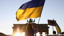 A person holds a Ukrainian flag during an anti-war demonstration Stop the War. Peace and Solidarity for the People in Ukraine against Russia's invasion of Ukraine, next to the Brandenburg Gate in Berlin, Germany, March 13, 2022. REUTERS/Christian Mang TPX IMAGES OF THE DAY 