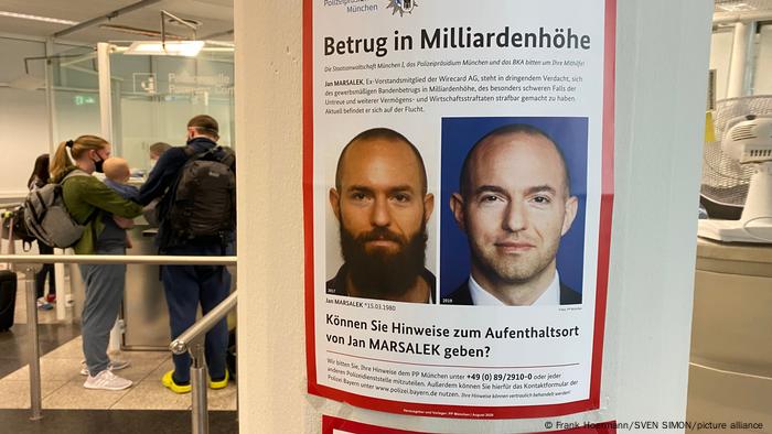 A German-language wanted poster for Jan Marsalek at an immigration-control checkpoint