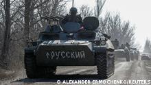 A view shows an armoured convoy of pro-Russian troops during Ukraine-Russia conflict outside the separatist-controlled town of Volnovakha in the Donetsk region, Ukraine March 12, 2022. A sign on an armoured vehicle reads: Russian. REUTERS/Alexander Ermochenko