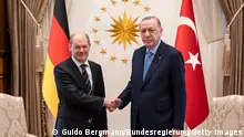 ANKARA, TURKEY - MARCH 14: In this handout images provided by German Government Press Office (BPA), Chancellor Olaf Scholz (L) and Turkish President Recep Tayyip Erdogan shake hands at the start of their meeting on March 14, 2022 in Ankara, Turkey. (Photo by Guido Bergmann/Bundesregierung via Getty Images)