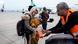 An Israeli man helps a Ukranian refugee with a baby, as she hands him a toy in Tel Aviv airport An Israeli man helps a Ukranian refugee with a baby, as she hands him a toy in Tel Aviv airport