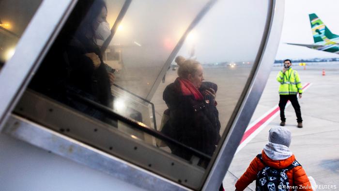 A Ukranian refugee from Kyiv walks off the aircraft in Tel Aviv