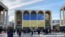 Ukraine's flag is draped outside The Metropolitan Opera House at Lincoln Center for the Performing Arts in New York before a benefit for Ukraine concert, Monday, March 14, 2022. (AP Photo/Ron Blum)