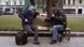 Two men playing chess on a park bench Two men playing chess on a park bench