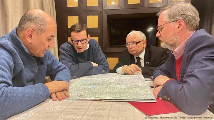 Eastern and central European leaders poring over a map of Ukraine