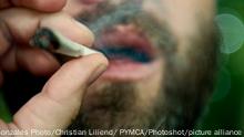 Man is inhaling a joint. Denmark 2012.