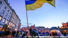 February 24, 2022, Cracow, Lesser Poland, Poland: A protester waves a Ukrainian flag during the protest..In response to Russian invasion of Ukraine, members of the Ukrainian community and supportive Poles and Belarusians protested near diplomatic missions of the Russian Federation to express their opposition to Russian military aggression. In Krakow, where Ukrainian immigration is particularly numerous, several thousand people marched through the city centre and gathered in front of the Russian consulate. (Credit Image: © Filip Radwanski/SOPA Images via ZUMA Press Wire