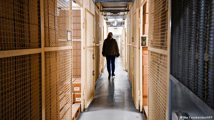 A woman walking past storage rooms