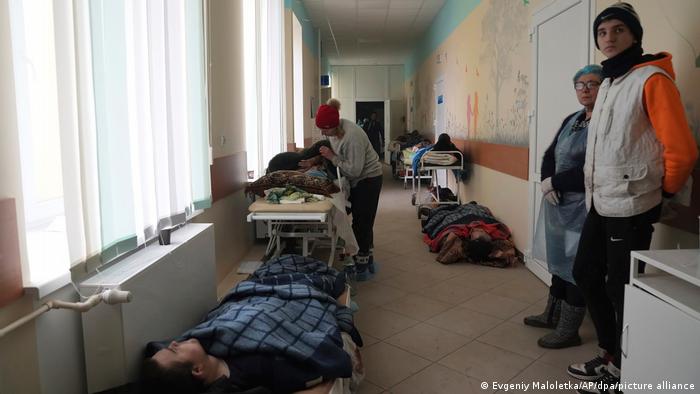 Injured lie in the corridor of a hospital