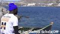 Malian migrant to Gran Canaria Madala Tounkara gazes out across small boat at port