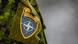 The NATO logo, seen on the shoulder of a soldier's uniform The NATO logo, seen on the shoulder of a soldier's uniform